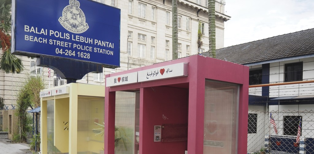 Mini libraries in Penang, Malaysia with multilingual boards.